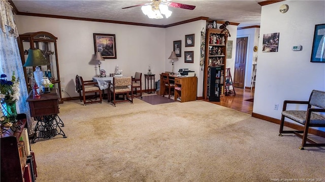 sitting room with a textured ceiling, ornamental molding, ceiling fan, and carpet