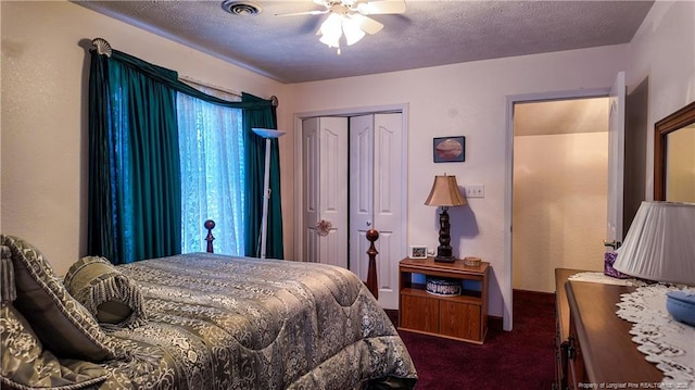 carpeted bedroom featuring ceiling fan, a closet, and a textured ceiling