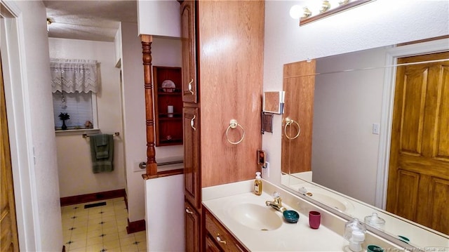 bathroom with vanity and a textured ceiling