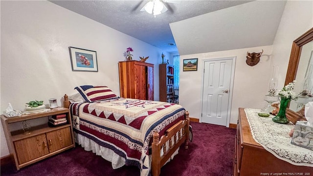 bedroom featuring dark carpet, a textured ceiling, and ceiling fan