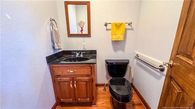 bathroom with vanity and hardwood / wood-style flooring