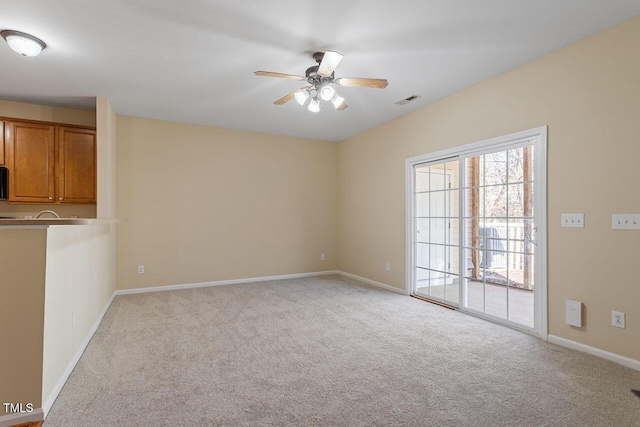 carpeted empty room featuring ceiling fan