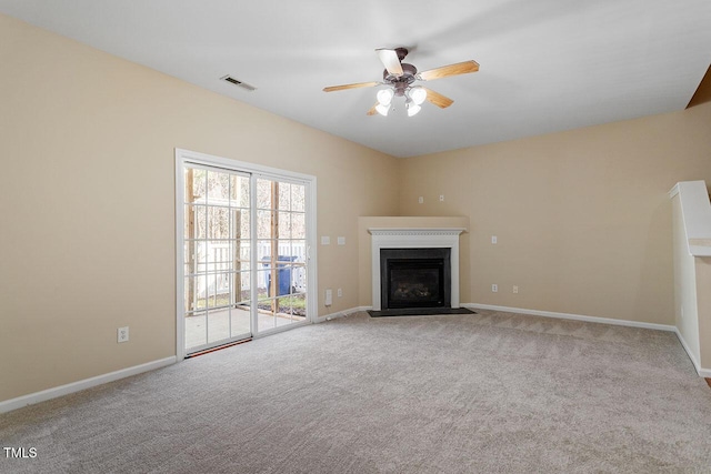 unfurnished living room featuring ceiling fan and light carpet