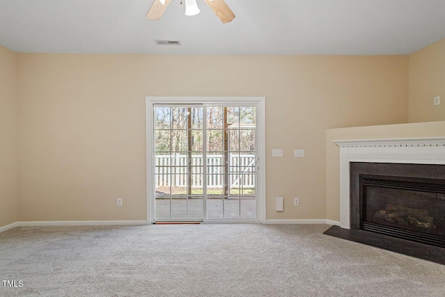 unfurnished living room with ceiling fan and carpet flooring