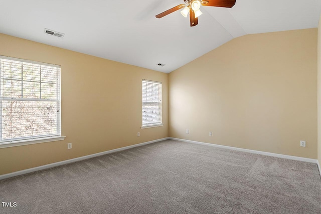 carpeted empty room with ceiling fan and vaulted ceiling