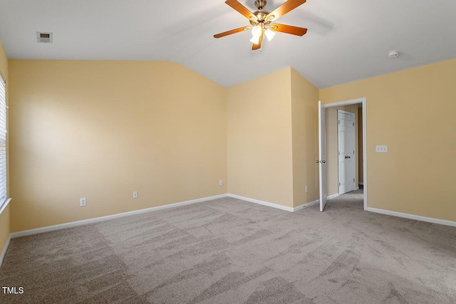 carpeted spare room with ceiling fan and lofted ceiling