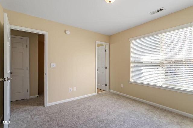 unfurnished bedroom with light colored carpet