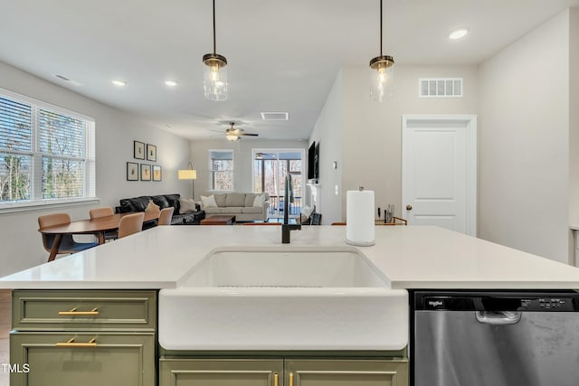 kitchen featuring ceiling fan, decorative light fixtures, green cabinetry, stainless steel dishwasher, and sink