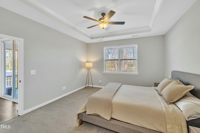 carpeted bedroom with a raised ceiling, access to outside, and ceiling fan