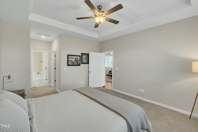 bedroom with light carpet, a raised ceiling, ceiling fan, ensuite bathroom, and crown molding