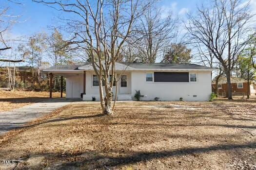 ranch-style home with a carport