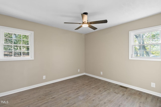 empty room with ceiling fan and wood-type flooring