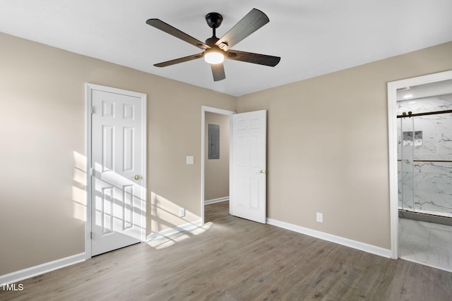 unfurnished bedroom with hardwood / wood-style flooring, connected bathroom, and ceiling fan