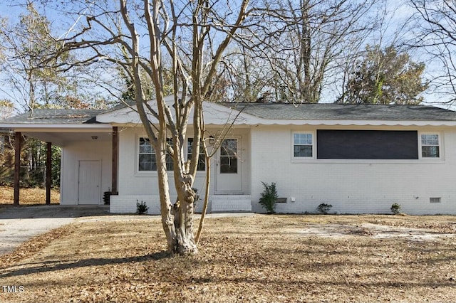 ranch-style home featuring a carport