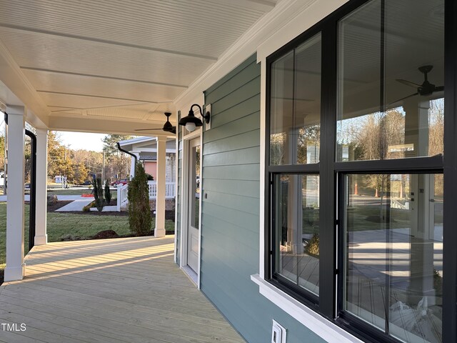 wooden terrace featuring covered porch