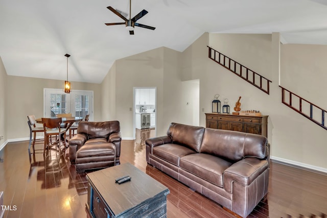 living room with dark wood-type flooring, high vaulted ceiling, and ceiling fan