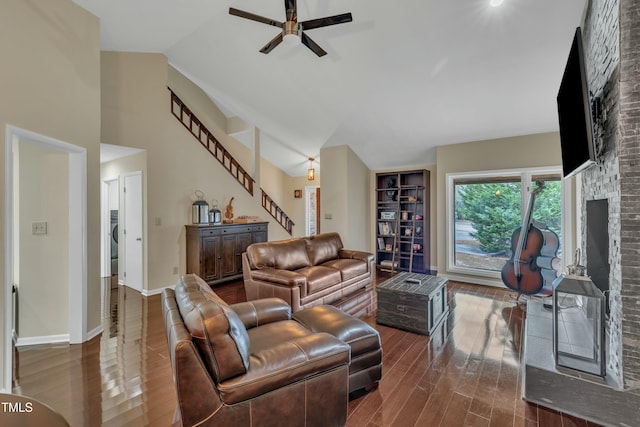 living room featuring ceiling fan, a fireplace, hardwood / wood-style floors, and vaulted ceiling