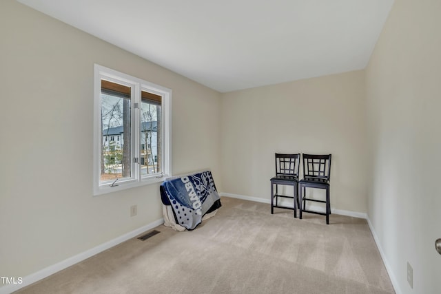 sitting room featuring light colored carpet