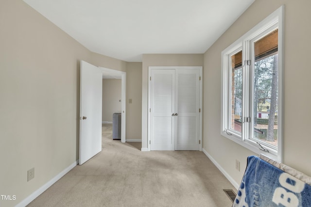 unfurnished room with light colored carpet