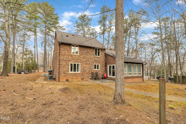 rear view of property featuring a sunroom, a patio, and central air condition unit