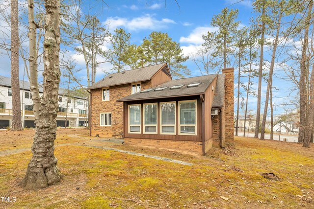 back of house featuring a yard