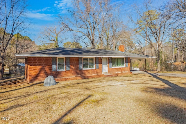 single story home featuring a front lawn and a carport