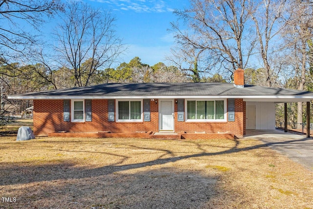 single story home with a front lawn and a carport