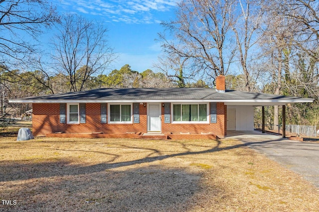 single story home with a front yard and a carport