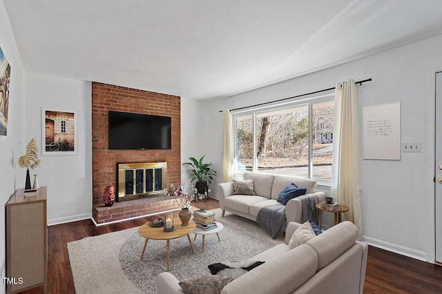 living room with dark wood-type flooring and a fireplace