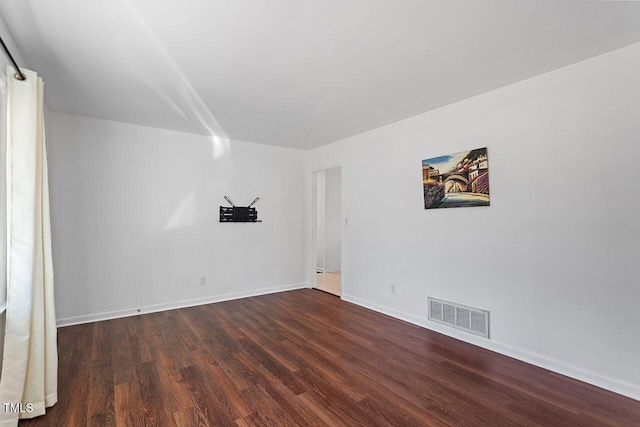 unfurnished room with dark hardwood / wood-style floors