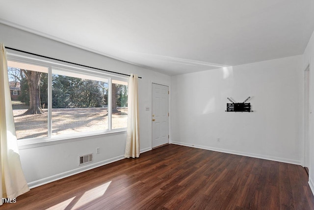 spare room with dark hardwood / wood-style flooring