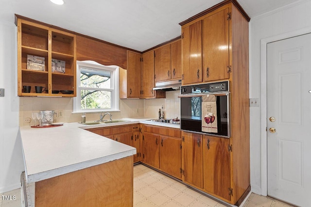 kitchen with decorative backsplash, sink, kitchen peninsula, and black appliances