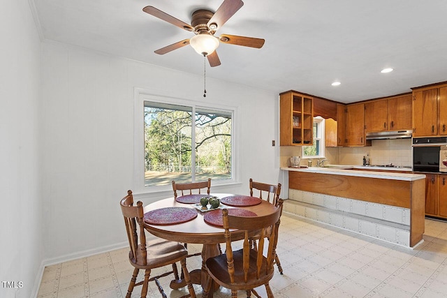 dining room featuring ceiling fan and sink