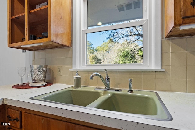 kitchen with sink and tasteful backsplash