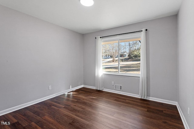 unfurnished room with dark hardwood / wood-style floors