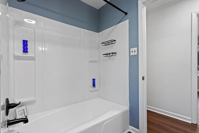 bathroom with tub / shower combination and hardwood / wood-style floors