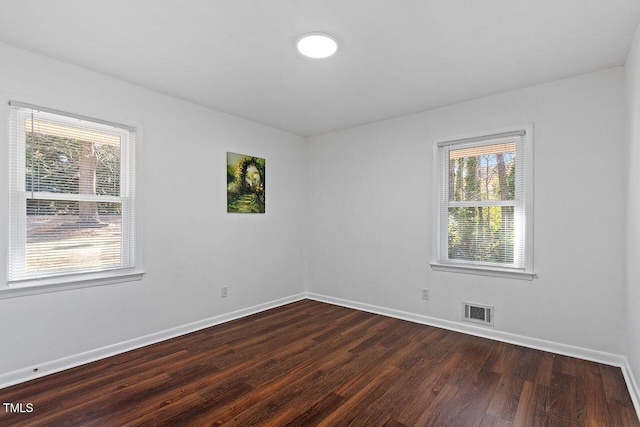 spare room featuring dark hardwood / wood-style floors