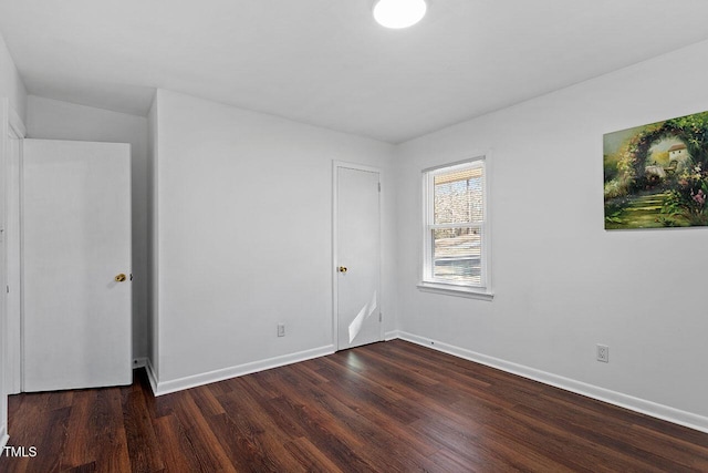 empty room featuring dark wood-type flooring