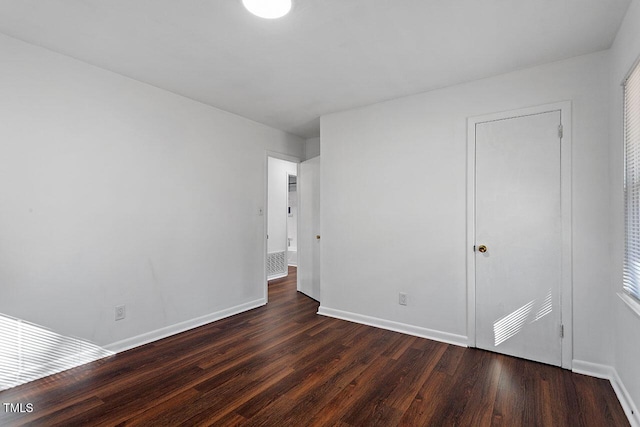 empty room featuring dark wood-type flooring