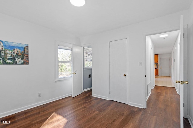 unfurnished bedroom with dark hardwood / wood-style floors