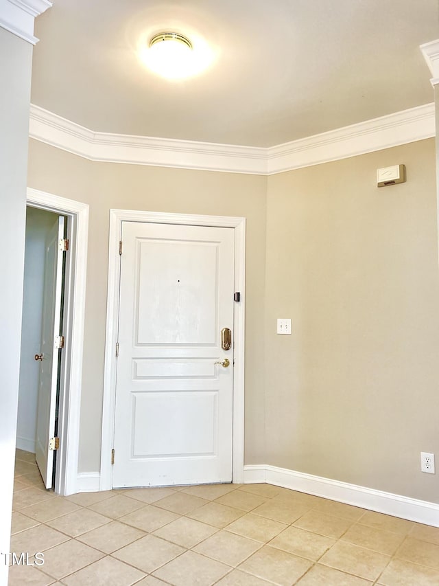 doorway to outside featuring light tile patterned flooring and ornamental molding