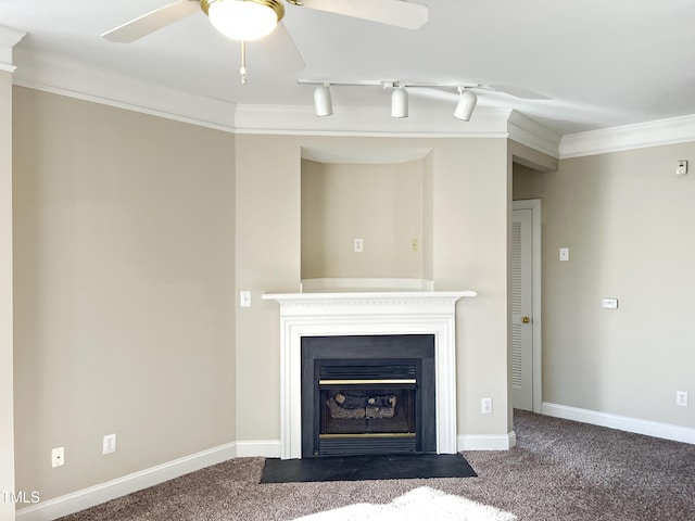 interior space with carpet floors, ceiling fan, crown molding, and rail lighting