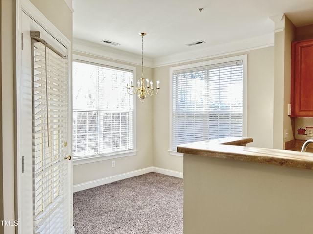 unfurnished dining area with crown molding, light carpet, and a chandelier