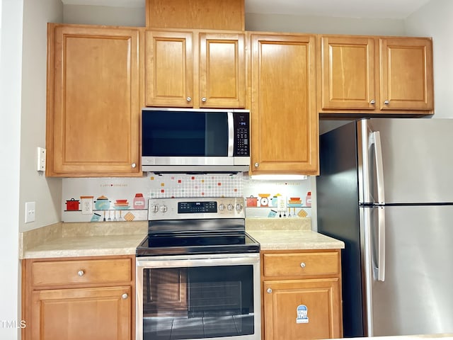 kitchen with backsplash and stainless steel appliances