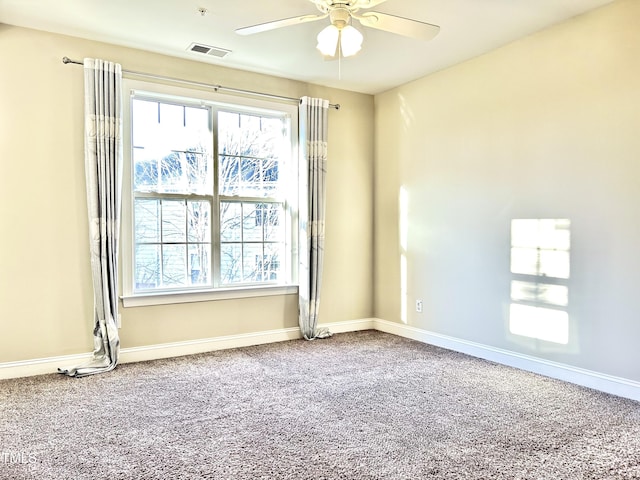 spare room featuring ceiling fan and carpet flooring