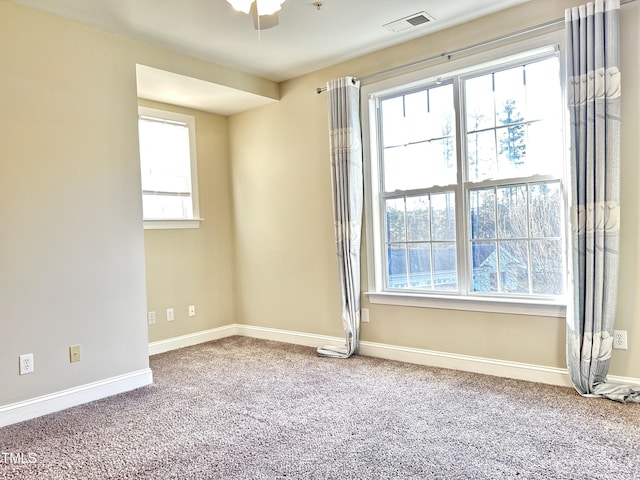 spare room featuring ceiling fan and carpet flooring