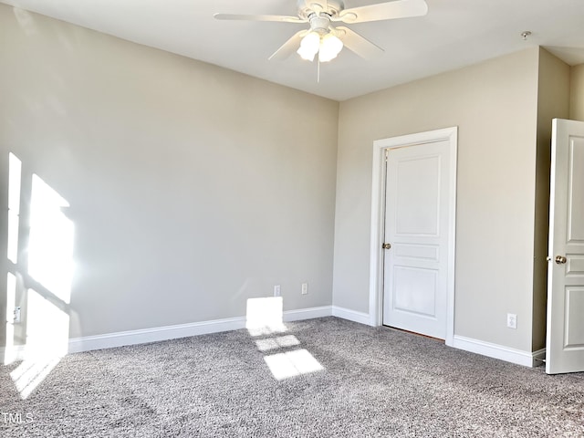 carpeted spare room with ceiling fan