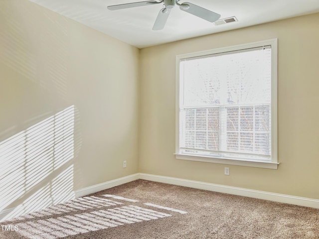 carpeted empty room featuring ceiling fan