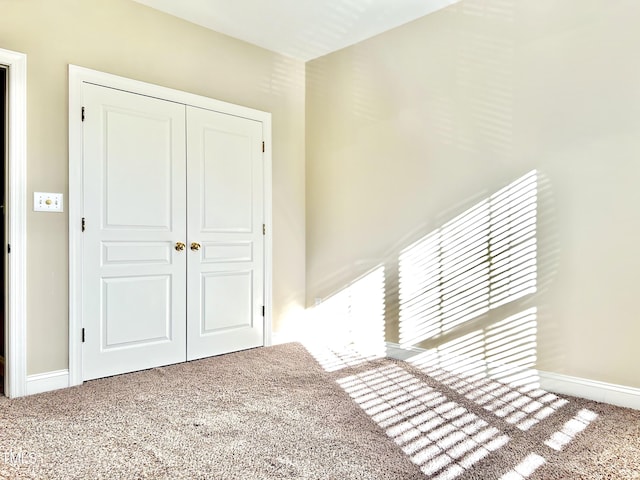 unfurnished bedroom featuring a closet and carpet