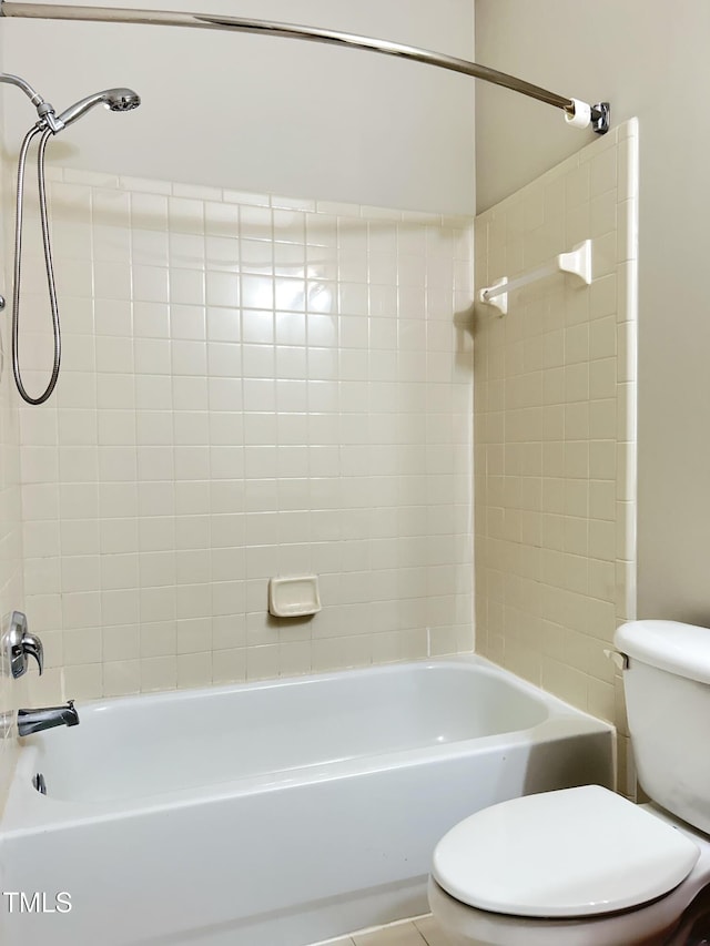 bathroom featuring toilet and tiled shower / bath combo